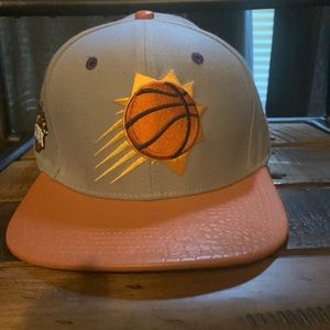 Phoenix suns flat brim lid.  Lid leathery material.  Never been worn